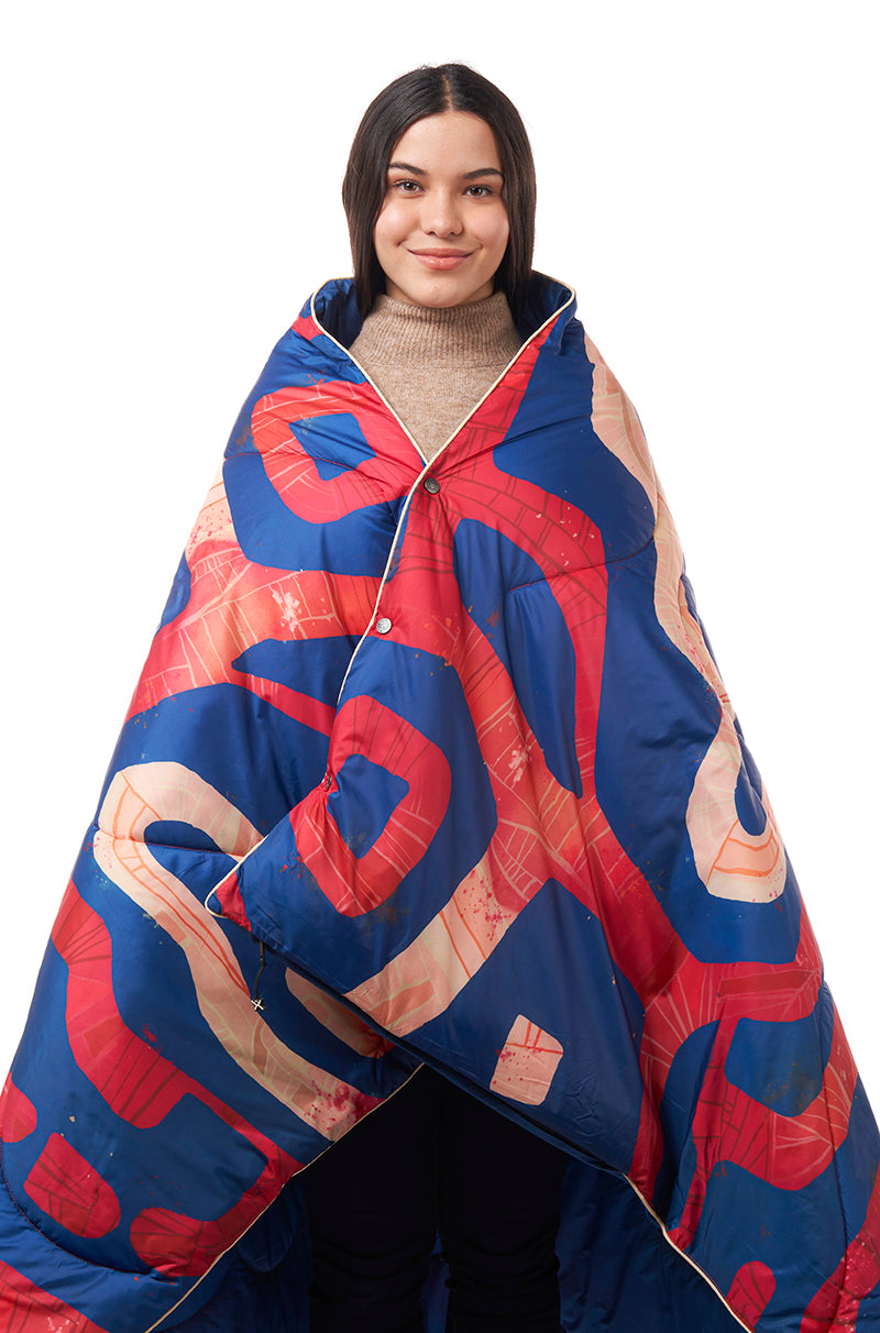 Teenage girl with Selk'bag sleeping bag blanket wrapped around her