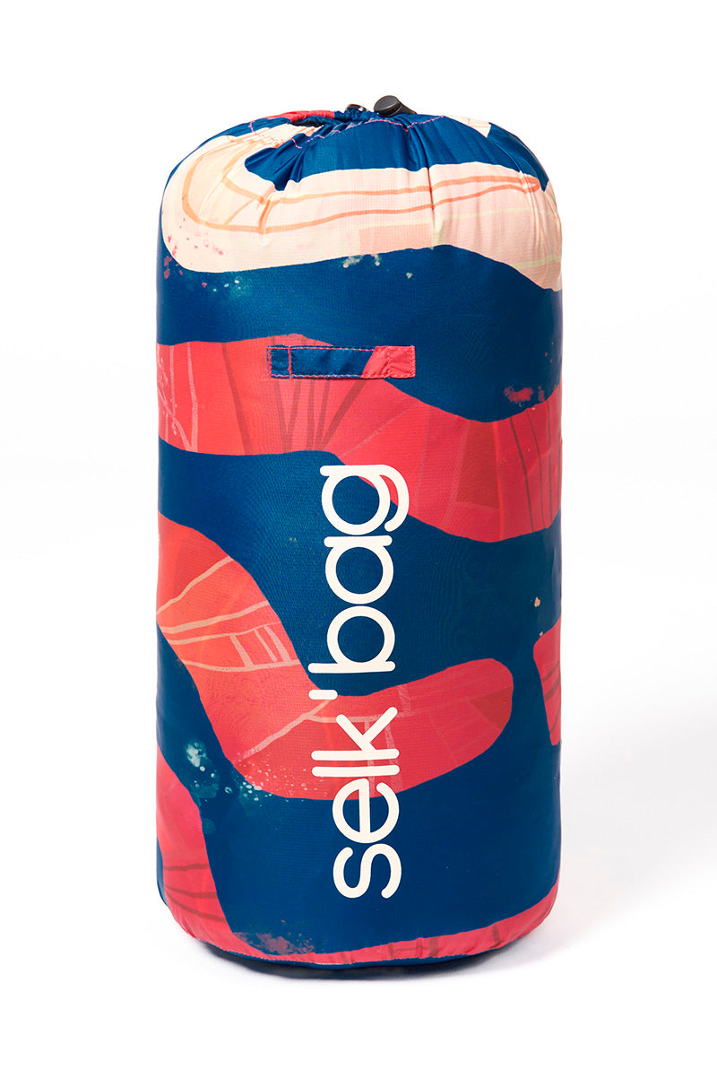 Selk'bag red and blue sleeping bag rolled up