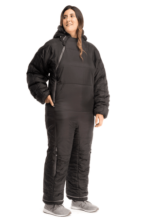 Adult woman wearing a Selk'bag sleeping bag onesie in black