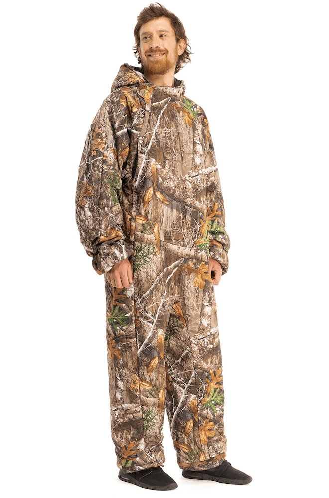 Adult man wearing a Selk'bag Pursuit Realtree® EDGE® camouflage sleeping bag onesie