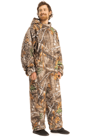 Adult man wearing a Selk'bag Pursuit Realtree® EDGE® camouflage sleeping bag onesie