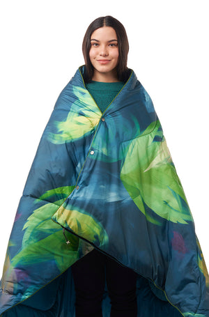 Woman wearing a sleeping bag blanket with a leaf pattern