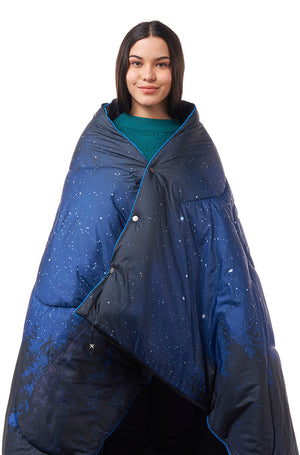 Woman wearing a sleeping bag blanket with a star pattern