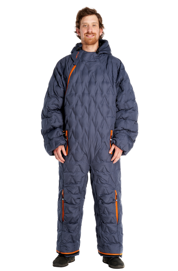 Adult man wearing a navy blue Selk'bag Nomad sleeping bag suit