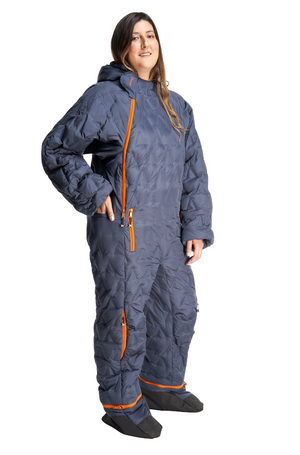 Adult woman wearing a navy blue Selk'bag Nomad sleeping bag onesie