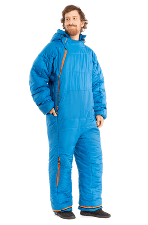 Adult man wearing a Selk'bag sleeping bag onesie in blue
